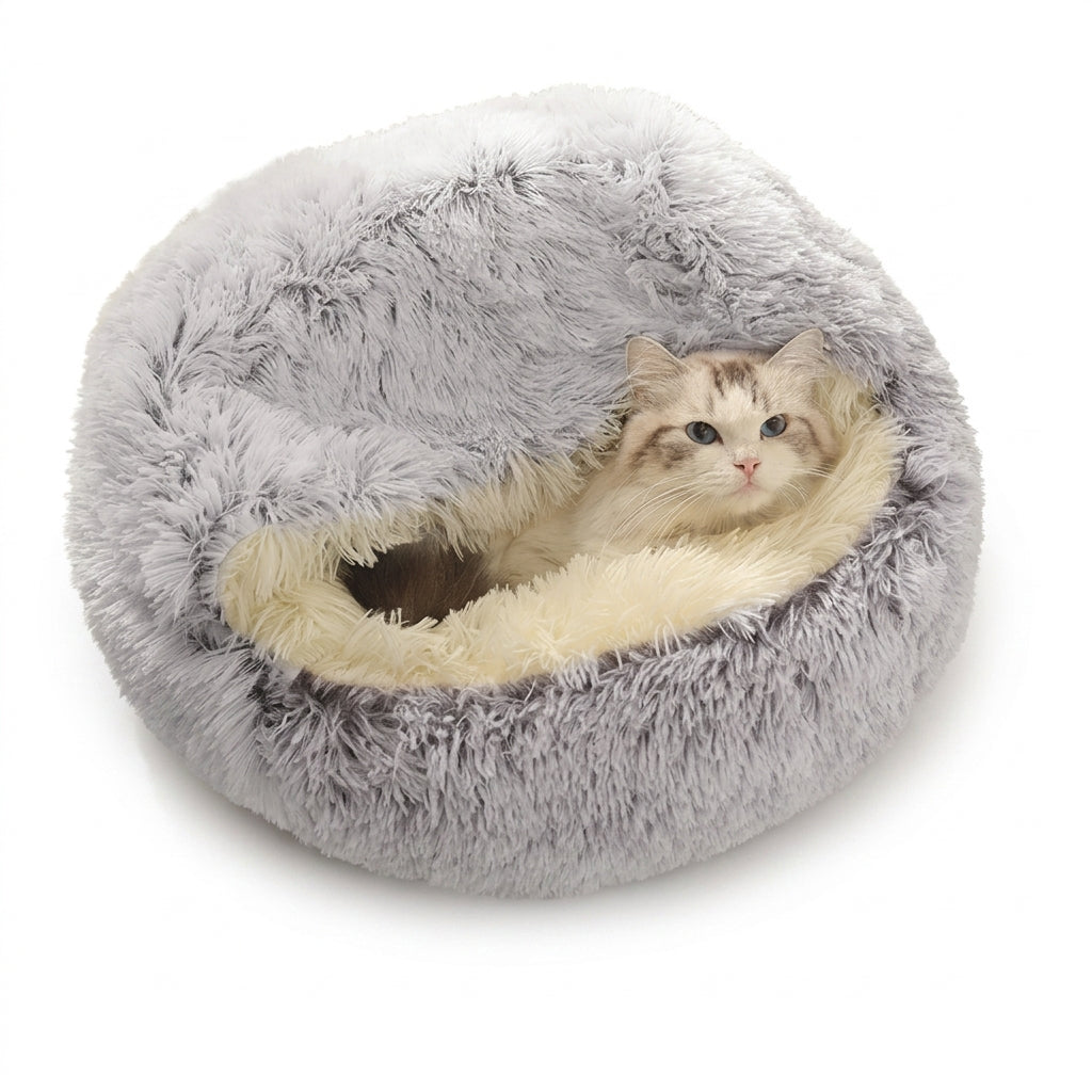 A fluffy round gray cat bed with a cream-colored lining, shown with a long-haired cat resting inside on a white background.